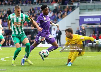 VIENNA, AUSTRIA - APRIL 12: Kelvin Boateng of Austria Wien competes with Nenad Cvetkovic and goalkeeper Niklas Hedl of Rapid during the Admiral Bundesliga match between  FK Austria Wien and SK Rapid at Generali Arena on April 12, 2026 in Vienna, Austria. (Photo by Thomas Pichler/SEPA.Media /Getty Images)