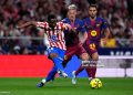 MADRID, SPAIN - APRIL 04: Taufik Seidu of Atletico de Madrid is challenged by Dani Olmo of FC Barcelona during the LaLiga EA Sports match between Atletico de Madrid and FC Barcelona at Riyadh Air Metropolitano on April 04, 2026 in Madrid, Spain. (Photo by Aitor Alcalde/Getty Images)