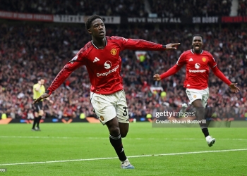 MANCHESTER, ENGLAND - MAY 03: Kobbie Mainoo of Manchester United celebrates scoring his team's third goal during the Premier League match between Manchester United and Liverpool at Old Trafford on May 03, 2026 in Manchester, England. (Photo by Shaun Botterill/Getty Images)