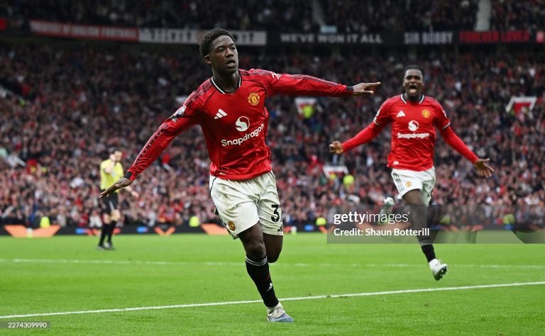 MANCHESTER, ENGLAND - MAY 03: Kobbie Mainoo of Manchester United celebrates scoring his team's third goal during the Premier League match between Manchester United and Liverpool at Old Trafford on May 03, 2026 in Manchester, England. (Photo by Shaun Botterill/Getty Images)