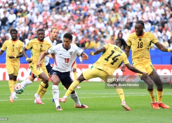 FOXBOROUGH, MASSACHUSETTS - JUNE 23: Jude Bellingham #10 of England is challenged by Gideon Mensah #14 of Ghana during the FIFA World Cup 2026 Group L match between England and Ghana at Boston Stadium on June 23, 2026 in Foxborough, Massachusetts. (Photo by Buda Mendes/Getty Images)