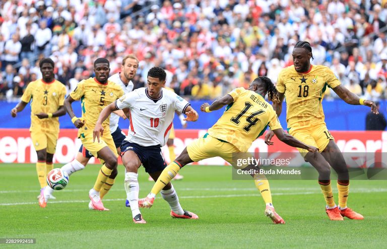 FOXBOROUGH, MASSACHUSETTS - JUNE 23: Jude Bellingham #10 of England is challenged by Gideon Mensah #14 of Ghana during the FIFA World Cup 2026 Group L match between England and Ghana at Boston Stadium on June 23, 2026 in Foxborough, Massachusetts. (Photo by Buda Mendes/Getty Images)