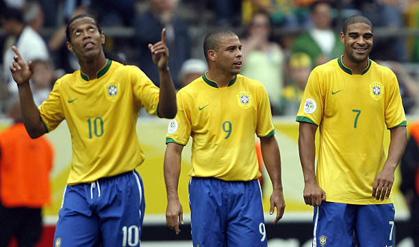 Dortmund, GERMANY: Brazilian forward Adriano (R) celebrates after scoring his team's second goal with Brazilian forward Ronaldo (C), who scored their first goal, as Brazilian midfielder Ronaldinho (L) gestures during the round of 16 World Cup football match between Brazil and Ghana at Dortmund's World Cup Stadium, 27 June 2006. Brazil were leading 2-0 at half-time. AFP PHOTO / VANDERLEI ALMEIDA (Photo credit should read VANDERLEI ALMEIDA/AFP via Getty Images)