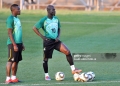 Ghana's midfielder Stephen Appiah (C) and midfielder Sulley Muntari (L) stand on the pitch as they take part in a training session at Mogwase stadium in Mogwase, north of Rustenburg, on June 10, 2010 ahead of the start of the 2010 World Cup football tournament. The 2010 World Cup will take place in South Africa from June 11 to July 11, the first time on African soil for the biggest and most prestigious competition in sport. AFP PHOTO / JUNG YEON-JE (Photo by JUNG YEON-JE / AFP via Getty Images)