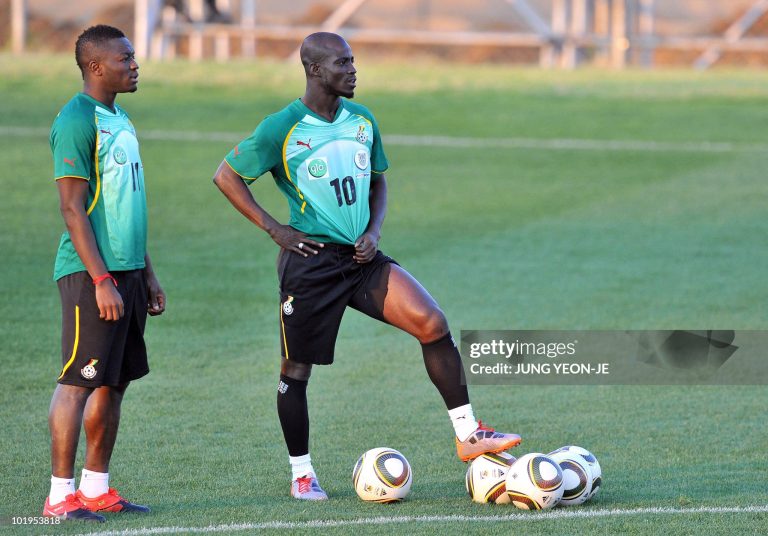 Ghana's midfielder Stephen Appiah (C) and midfielder Sulley Muntari (L) stand on the pitch as they take part in a training session at Mogwase stadium in Mogwase, north of Rustenburg, on June 10, 2010 ahead of the start of the 2010 World Cup football tournament. The 2010 World Cup will take place in South Africa from June 11 to July 11, the first time on African soil for the biggest and most prestigious competition in sport. AFP PHOTO / JUNG YEON-JE (Photo by JUNG YEON-JE / AFP via Getty Images)