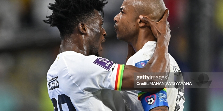 TOPSHOT - Ghana's midfielder #10 Andre Ayew (L) celebrates with Ghana's midfielder #20 Mohammed Kudus after scoring his team's first goal during the Qatar 2022 World Cup Group H football match between Portugal and Ghana at Stadium 974 in Doha on November 24, 2022. (Photo by MANAN VATSYAYANA / AFP via Getty Images)