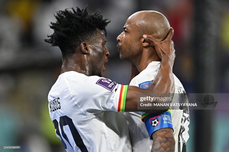 TOPSHOT - Ghana's midfielder #10 Andre Ayew (L) celebrates with Ghana's midfielder #20 Mohammed Kudus after scoring his team's first goal during the Qatar 2022 World Cup Group H football match between Portugal and Ghana at Stadium 974 in Doha on November 24, 2022. (Photo by MANAN VATSYAYANA / AFP via Getty Images)