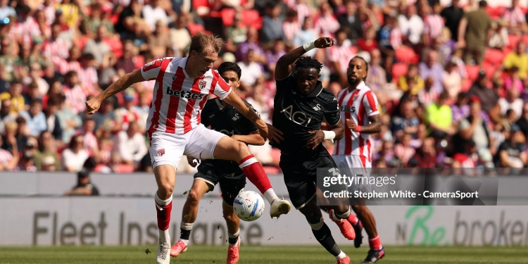 STOKE ON TRENT, ENGLAND - AUGUST 15:  Stoke City's Svante Ingelsson shields the ball from Swansea City's Joseph Opoku during the Sky Bet Championship 2026/27 match between Stoke City and Swansea City at Bet365 Stadium on August 15, 2026 in Stoke on Trent, England. (Photo by Stephen White - CameraSport via Getty Images)
