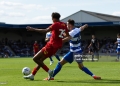 WIMBLEDON, ENGLAND - AUGUST 1: Harvey Vale of Queens Park Rangers tackles Aron Sasu of AFC Wimbledon during the pre-season friendly match between AFC Wimbledon and Queens Park Rangers at The Cherry Red Records Stadium on August 1, 2026 in Wimbledon, England. (Photo by Sarah Ray-Gain/Getty Images)