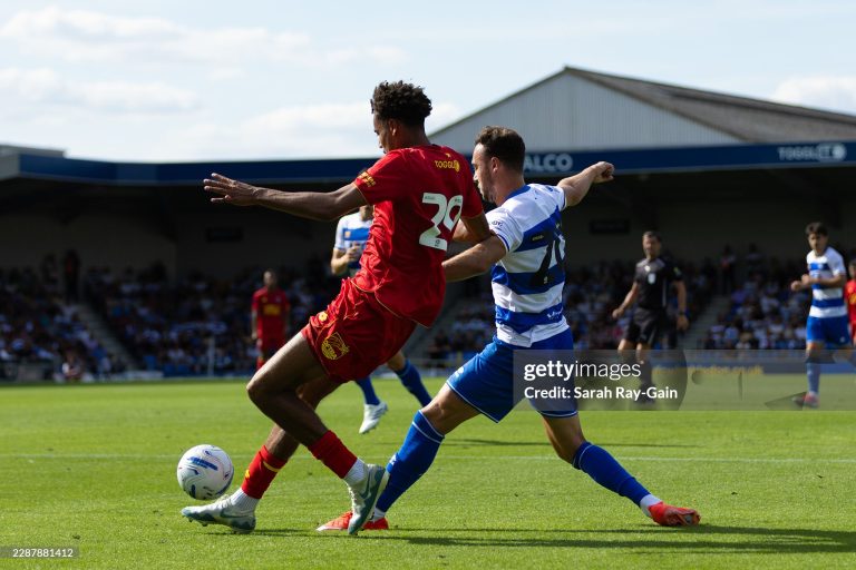 WIMBLEDON, ENGLAND - AUGUST 1: Harvey Vale of Queens Park Rangers tackles Aron Sasu of AFC Wimbledon during the pre-season friendly match between AFC Wimbledon and Queens Park Rangers at The Cherry Red Records Stadium on August 1, 2026 in Wimbledon, England. (Photo by Sarah Ray-Gain/Getty Images)