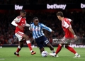 LONDON, ENGLAND - AUGUST 21: Brandon Thomas-Asante of Coventry City is challenged by Cristhian Mosquera and Ben White of Arsenal during the Premier League 2026/27 match between Arsenal FC and Coventry City at Emirates Stadium on August 21, 2026 in London, England. (Photo by Julian Finney/Getty Images)