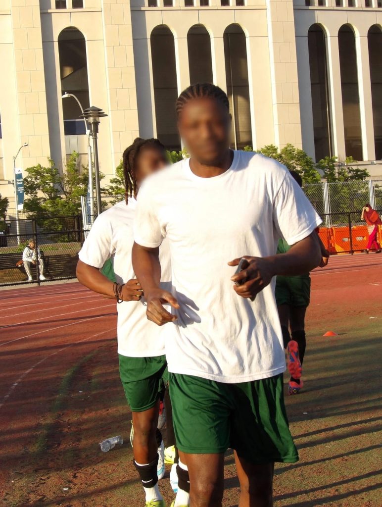Abdul (front) withbblurred face warming up at the Yankee side pitch
