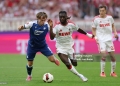 COLOGNE, GERMANY - AUGUST 29: Patrick Wimmer of TSG 1899 Hoffenheim is challenged by Gideon Mensah of 1.FC Koln during the Bundesliga 2026/27 match between 1. FC Köln and TSG Hoffenheim at RheinEnergieStadion on August 29, 2026 in Cologne, Germany. (Photo by Lars Baron/Getty Images)