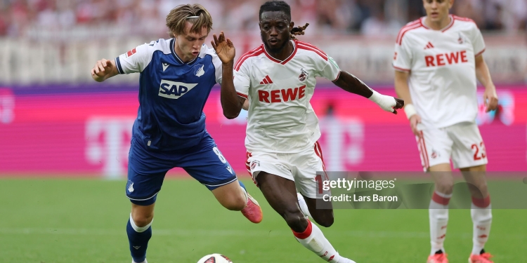 COLOGNE, GERMANY - AUGUST 29: Patrick Wimmer of TSG 1899 Hoffenheim is challenged by Gideon Mensah of 1.FC Koln during the Bundesliga 2026/27 match between 1. FC Köln and TSG Hoffenheim at RheinEnergieStadion on August 29, 2026 in Cologne, Germany. (Photo by Lars Baron/Getty Images)