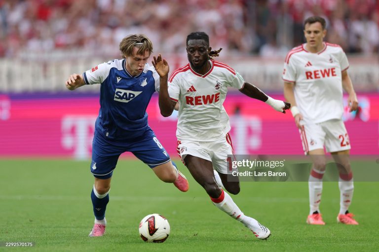 COLOGNE, GERMANY - AUGUST 29: Patrick Wimmer of TSG 1899 Hoffenheim is challenged by Gideon Mensah of 1.FC Koln during the Bundesliga 2026/27 match between 1. FC Köln and TSG Hoffenheim at RheinEnergieStadion on August 29, 2026 in Cologne, Germany. (Photo by Lars Baron/Getty Images)