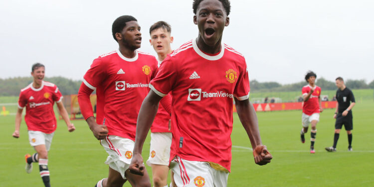 MANCHESTER, ENGLAND - SEPTEMBER 25: Kobbie Mainoo of Manchester United U18s celebrates Marc Jurado scoring their first goalduring the U18 Premier League match between Manchester United U18s and Stoke City U18s at Carrington Training Ground on September 25, 2021 in Manchester, England. (Photo by John Peters/Manchester United via Getty Images)