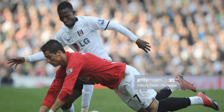 Manchester United's Cristiano Ronaldo (right) and Fulham's John Pantsil (left) battle for the ball. (Photo by Anthony Devlin - PA Images/PA Images via Getty Images)